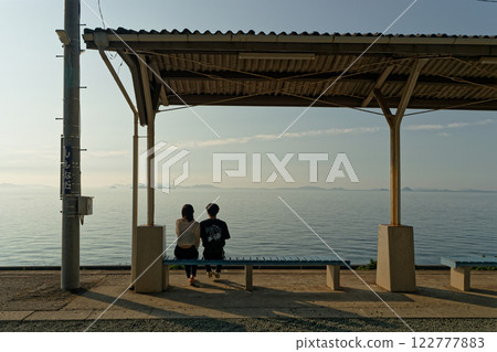 A couple waiting for a train on the platform 122777883