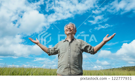 Senior man raising his arms in the air 122777931