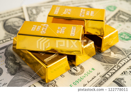 Gold bars with US dollar banknote money, finance trading investment business currency. Gold bars with US dollar banknote money, finance trading investment business currency. 122778011