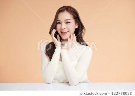 Beautiful young asian woman with clean fresh skin on beige background, Face care, Facial treatment, Cosmetology, beauty and spa, Asian women portrait. 122778058