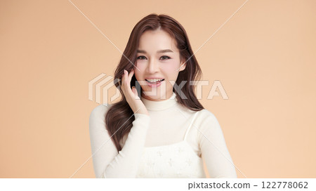 Beautiful young asian woman with clean fresh skin on beige background, Face care, Facial treatment, Cosmetology, beauty and spa, Asian women portrait. Beautiful young asian woman with clean fresh skin on beige background, Face care, Facial treatment, Cosmetology, beauty and spa, Asian women portrait. 122778062