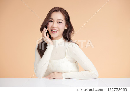 Beautiful young asian woman with clean fresh skin on beige background, Face care, Facial treatment, Cosmetology, beauty and spa, Asian women portrait. Beautiful young asian woman with clean fresh skin on beige background, Face care, Facial treatment, Cosmetology, beauty and spa, Asian women portrait. 122778063