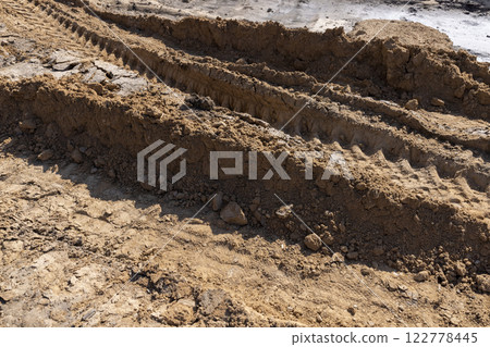 a deep hole in the ground on the site of which a highway was started 122778445