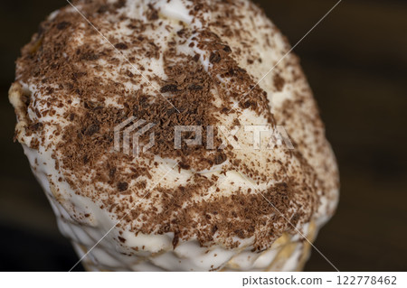 sweet melting white ice cream with chocolate chips in a waffle cone 122778462