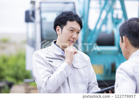 建築工地的工人:一名男子在平板電腦上查看工作詳情 建築工地的工人:一名男子在平板電腦上查看工作詳情 122779957