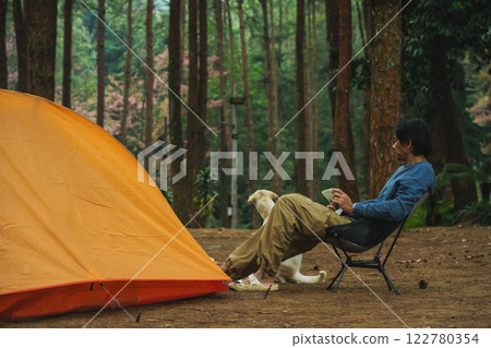 solo traveler in nature concept with asian man camping and work online with pink cherry blossom and pine tree in springtime season solo traveler in nature concept with asian man camping and work online with pink cherry blossom and pine tree in springtime season 122780354