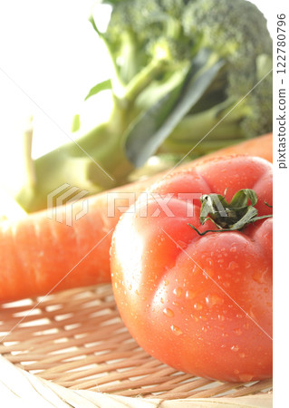 Tomatoes, carrots and broccoli photographed on a white background 122780796