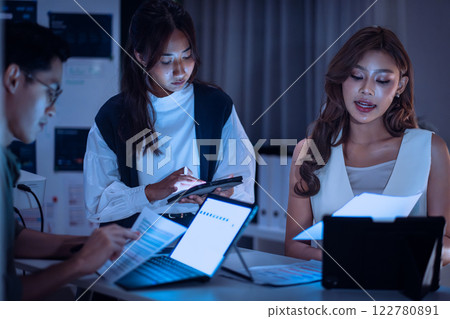 team of financial discussion budget planning, analyzing digital financial data and strategy in a modern office at night team of financial discussion budget planning, analyzing digital financial data and strategy in a modern office at night 122780891