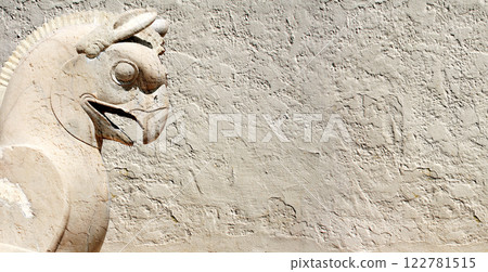 Background with stone statue of mythical griffin, Persepolis, Iran. Horizontal banner with assyrian protective deity. Topic of summer vacation, travel, trip abroad on vacation, cruises and tours 122781515