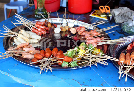 Traditional asian street food, Myanmar (Burma), Southeast Asia. Fresh snack food on Stick on street fish market Traditional asian street food, Myanmar (Burma), Southeast Asia. Fresh snack food on Stick on street fish market 122781520