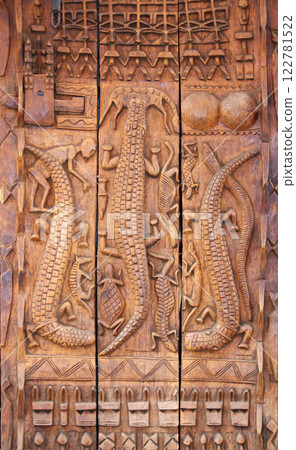 Traditional moroccan wood carving shutter with animals like crocodiles, turtle, antelope. Street shop of traveller souvenirs in medina of Marrakech, Morocco. Tourist wooden souvenir on market street Traditional moroccan wood carving shutter with animals like crocodiles, turtle, antelope. Street shop of traveller souvenirs in medina of Marrakech, Morocco. Tourist wooden souvenir on market street 122781522