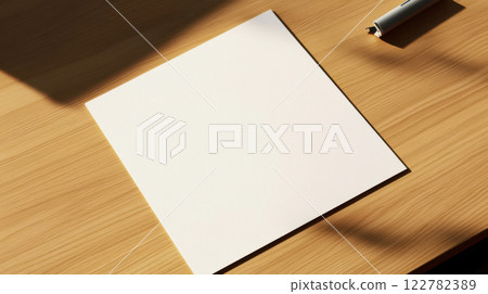 clean piece of note paper on wooden desk with pen nearby 122782389