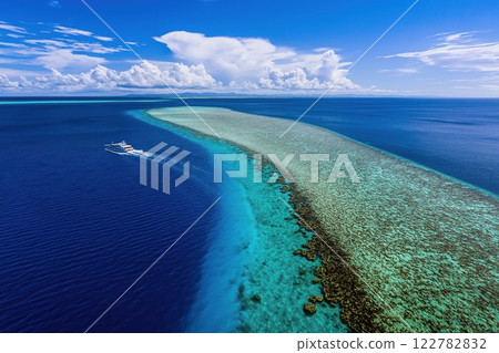 Aerial view of a passenger ferry sailing in the ocean near a coral reef in a tropical paradise 122782832