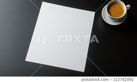 blank sheet of paper beside cup of coffee on dark table blank sheet of paper beside cup of coffee on dark table 122782892
