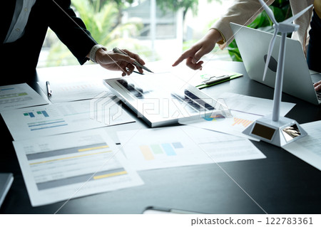 The management team is meeting to listen to proposals for energy saving equipment  renewable energy  solar energy  wind energy 122783361