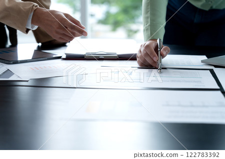 In Marketing brainstrom meeting The team is standing and pointing In Marketing brainstrom meeting The team is standing and pointing 122783392