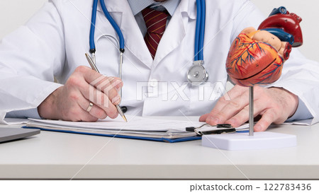 Anatomical model human heart on work desk of doctor in medical clinic. Anatomical model human heart on work desk of doctor in medical clinic. 122783436