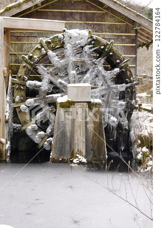 Snow-covered and frozen watermill Snow-covered and frozen watermill 122784164