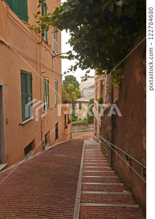 Traditional buildings and steps, pedestrianized narrow streets of old town. Genoa and medieval architecture of Italy. Windows and doors. Traditional buildings and steps, pedestrianized narrow streets of old town. Genoa and medieval architecture of Italy. Windows and doors. 122784680