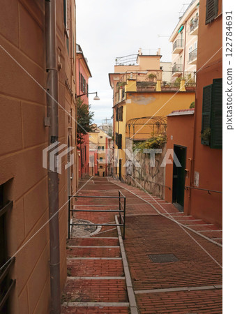 Traditional buildings and steps, walking narrow streets of old town. Genoa and medieval architecture of Italy. Windows and doors. Traditional buildings and steps, walking narrow streets of old town. Genoa and medieval architecture of Italy. Windows and doors. 122784691