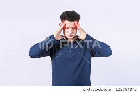 Concept of a man with a headache, man rubbing his head on isolated background, guy giving himself a head massage, concept of a man with a migraine Concept of a man with a headache, man rubbing his head on isolated background, guy giving himself a head massage, concept of a man with a migraine 122784876