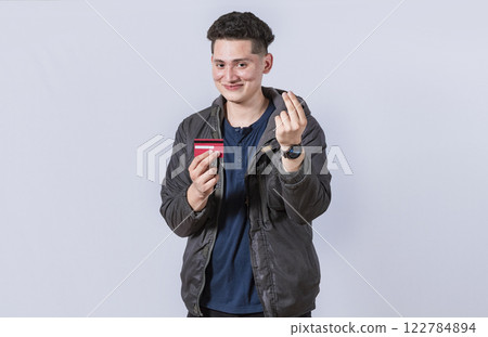 Handsome man holding credit card, A guy holding credit card smiling, electronic payment concept Handsome man holding credit card, A guy holding credit card smiling, electronic payment concept 122784894