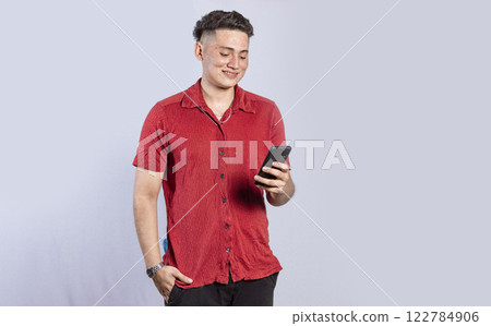 Handsome guy happy with his cell phone, young latin man happy with his cell phone Handsome guy happy with his cell phone, young latin man happy with his cell phone 122784906