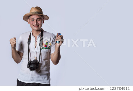 tourist in a hat with a camera, Happy tourist in a hat with a camera around his neck 122784911