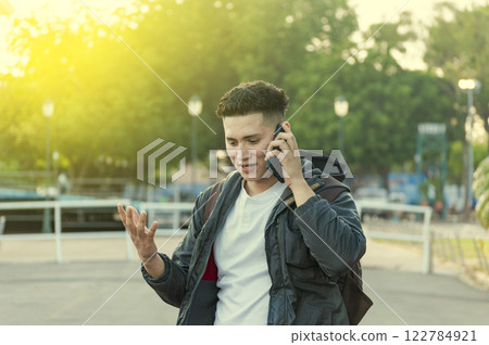 Man calling on the phone, young man calling on cell phone, latin guy calling on the phone Man calling on the phone, young man calling on cell phone, latin guy calling on the phone 122784921