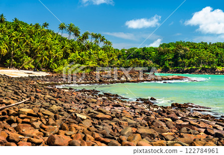 Tropical stone beach on Saint Joseph Island, Part of the Salvation Islands in French Guiana, South America 122784961