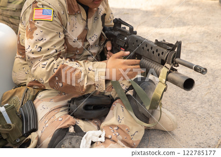 Team of U.S. Army marine corps soldier military war with gun weapon participating and preparing to attack the enemy in Thailand during exercise Cobra Gold training in battle. Combat force. Team of U.S. Army marine corps soldier military war with gun weapon participating and preparing to attack the enemy in Thailand during exercise Cobra Gold training in battle. Combat force. 122785177