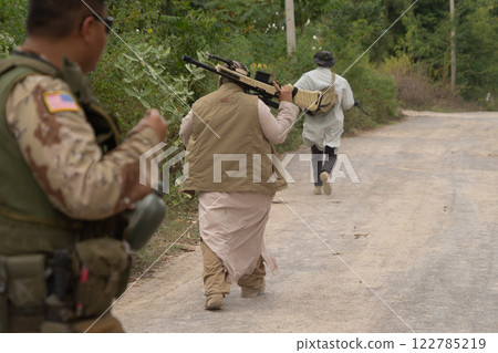 Team of U.S. Army marine corps soldier military war with gun weapon participating and preparing to attack the enemy in Thailand during exercise Cobra Gold training in battle. Combat force. 122785219