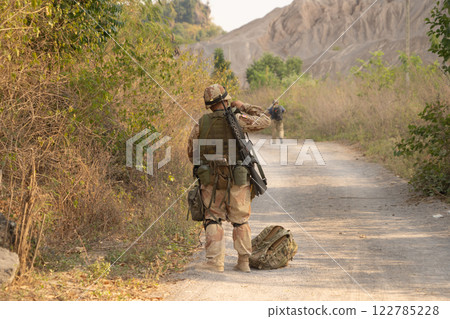 Team of U.S. Army marine corps soldier military war with gun weapon participating and preparing to attack the enemy in Thailand during exercise Cobra Gold training in battle. Combat force. 122785228