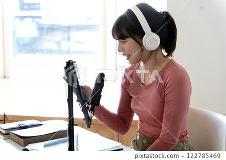 Young asian woman are using smart phones along with other forms of communication Young asian woman are using smart phones along with other forms of communication 122785469