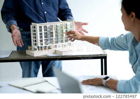 Architects and engineers team are pointing out and explaining Architects and engineers team are pointing out and explaining 122785497