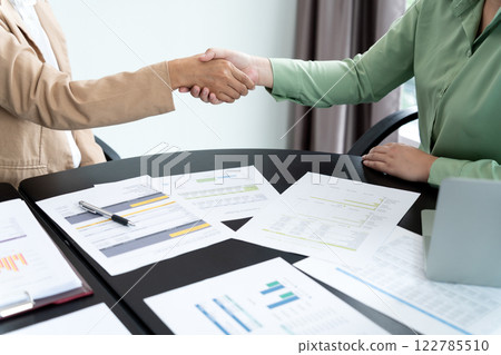 In the brainstorming meeting Executives shake hands and come to an agreement to show 122785510