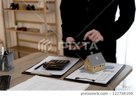 real estate agent woman is preparing documents and information real estate agent woman is preparing documents and information 122786109