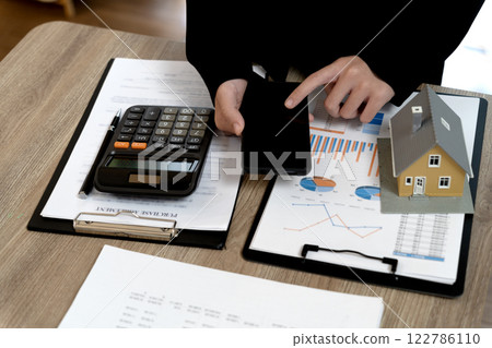real estate agent woman is preparing documents and information real estate agent woman is preparing documents and information 122786110