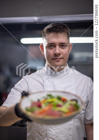 Chef holding gourmet salad Chef holding gourmet salad 122786698