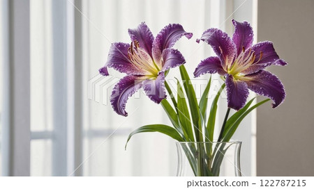 beautiful bouquet of purple lilies in a clear glass vase, illuminated by natural light, bringing a touch of nature's elegance to an indoor space beautiful bouquet of purple lilies in a clear glass vase, illuminated by natural light, bringing a touch of nature's elegance to an indoor space 122787215
