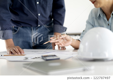 Architect or engineer are discussing and consulting in the office 122787497