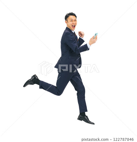 Middle-aged male businessman jumping while looking at his smartphone. Full-body photo PNG with transparent background precisely cut out by hand 122787846