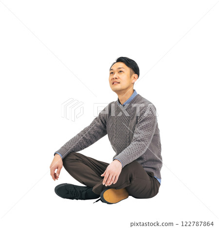 A middle-aged man in casual clothing sitting and looking up at the sky. A transparent full-body photo PNG precisely cut by hand 122787864