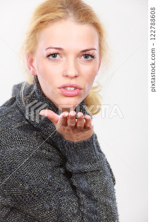 Flirty coquet blonde woman sending air kiss 122788608