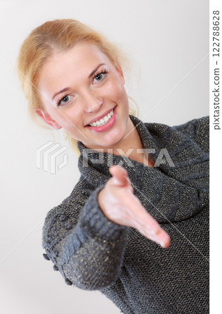 Happy woman looking at camera greeting 122788628