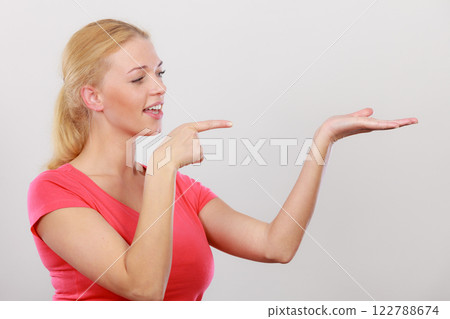 Happy woman pointing on right side Happy woman pointing on right side 122788674