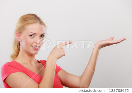 Happy woman pointing on right side Happy woman pointing on right side 122788675