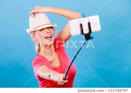 Tourist blonde woman taking pictures with phone Tourist blonde woman taking pictures with phone 122788707