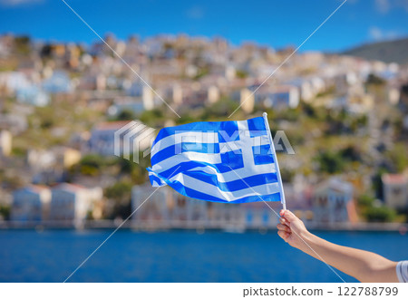 View of Greek flag waving in air serene Mediterranean vibe. View of Greek flag waving in air serene Mediterranean vibe. 122788799