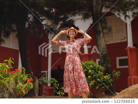 woman in dress and hat exploring vibrant streets of Malacca, Malaysia. woman in dress and hat exploring vibrant streets of Malacca, Malaysia. 122788819